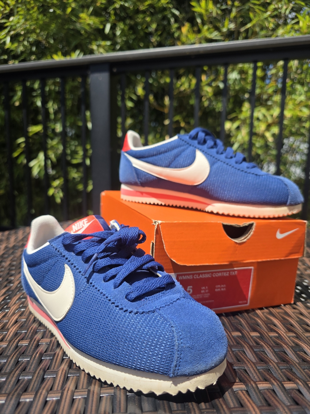 Nike Blue Mesh Athletic Sneakers with White Swoosh and Red Heel Accent